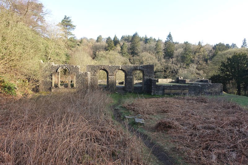 The ruins of Errwood Hall set amongst heather